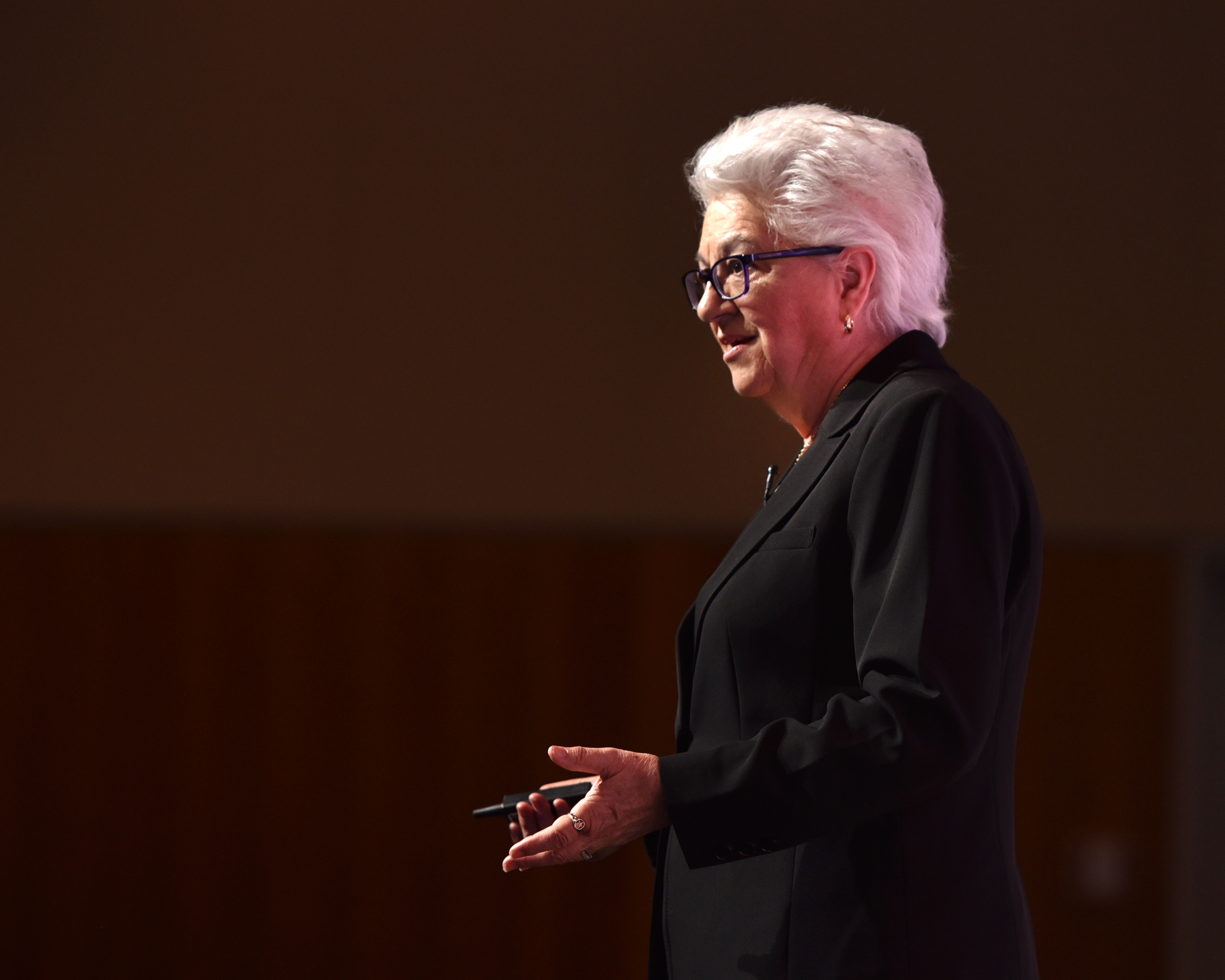 Michelle Causton presenting on stage — founder of BZMind